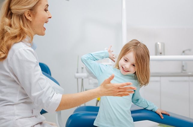 Young patient giving dentist a high five