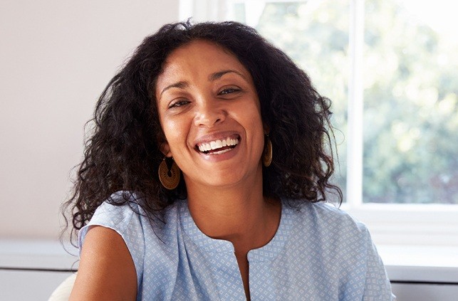 Woman sharing flawless smile after cosmetic dental bonding