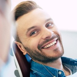 Man with white, straight teeth smiling at dentist