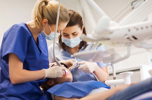 Dentist in Fitchburg conducting a tooth extraction