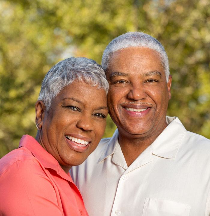 Older man and woman with healthy smiles after visiting their dentist in Fitchburg