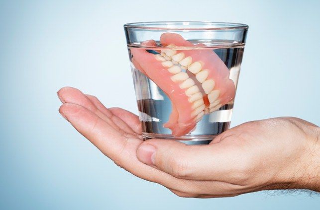 Full denture in glass of water