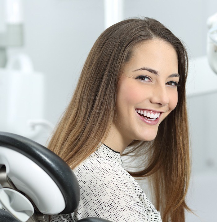 Woman sharing healthy smile after preventive dentistry visit