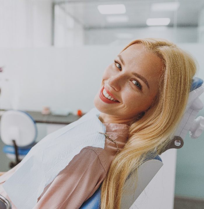 Woman smiling while relaxing in dentist's treatment chair