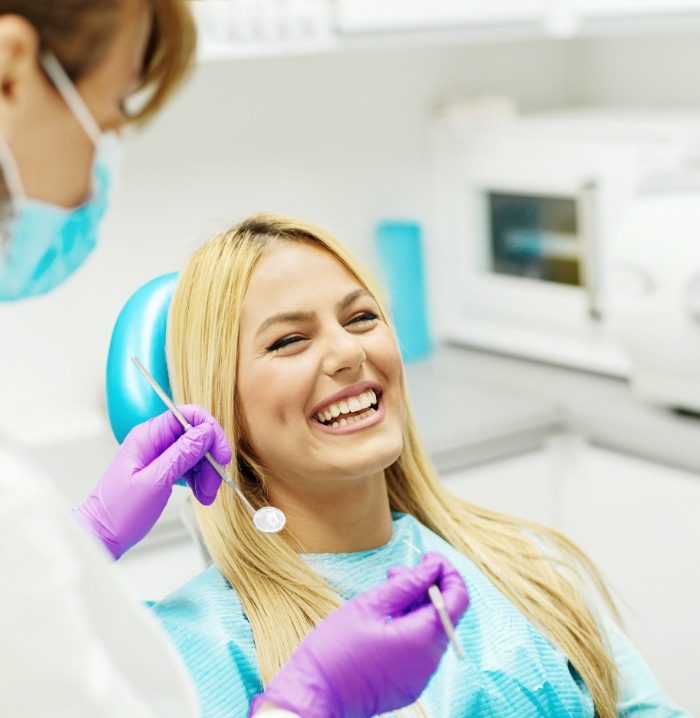 Woman laughing while receiving dental services in Fitchburge Massachusetts