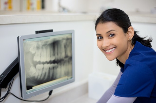 Woman looking at panoramic dental x-rays