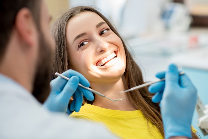 Woman smiling at dentist during dental checkup