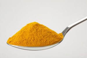 Closeup of spoon of turmeric for teeth whitening in Fitchburg
