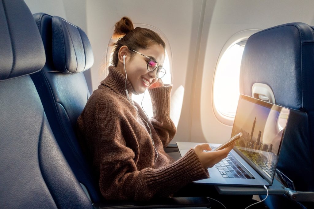 Woman smiling while working on airplane