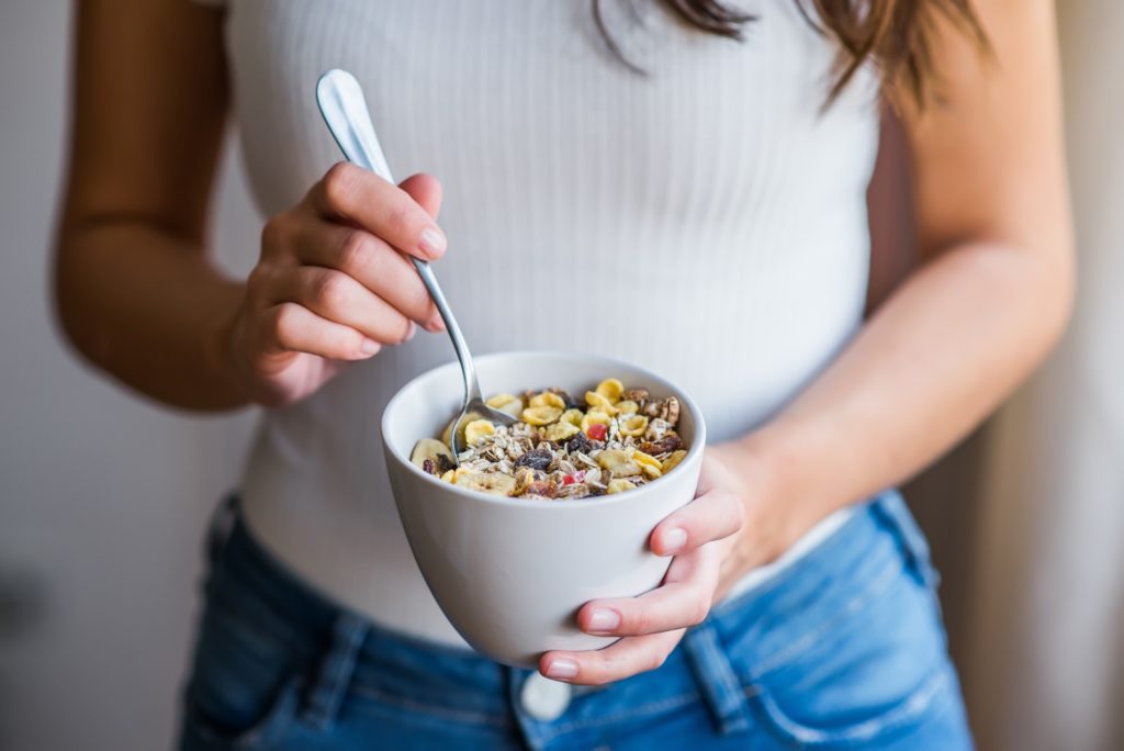 Closeup of woman holding bowl of oatmeal