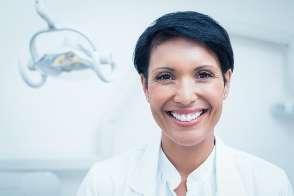 Closeup of female dentist smiling in dental office